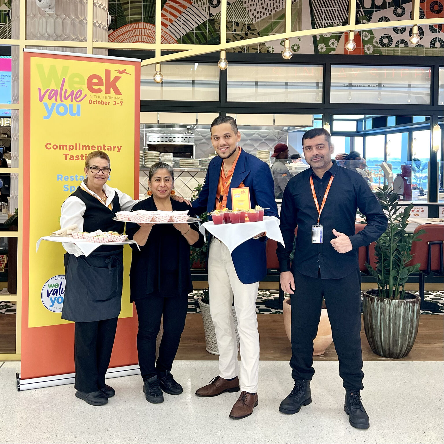 Airport team standing in front of restaurant with tastings